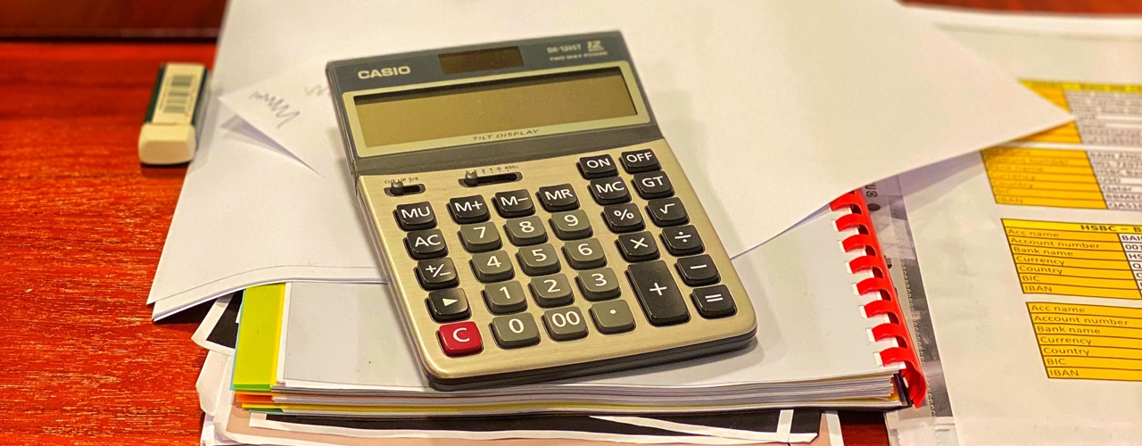A calculator and a notebook on the table is used on How to compute overtime pay in the Philippines