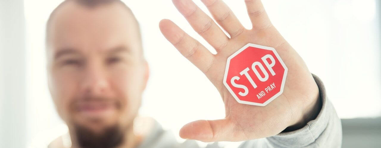 A "stop" sticker on a man's hand because he cannot file maternity leave in behalf of her wife as per the Maternity leave guidelines